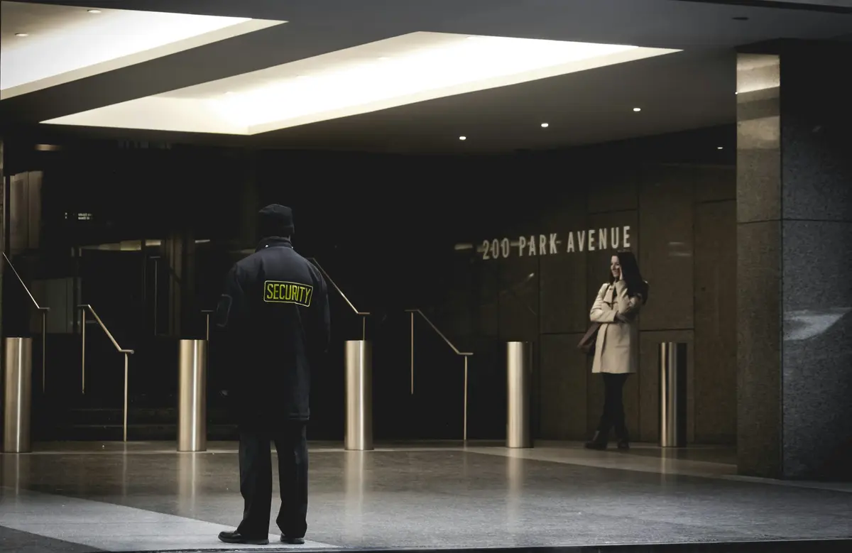 A uniformed security guard on duty, the kind of visible, professional presence that helps a security company win new clients