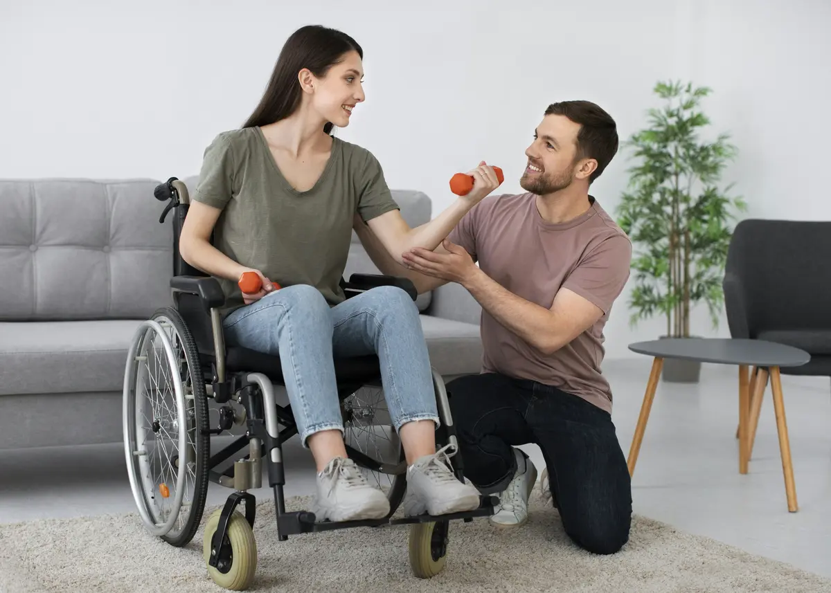 Caregiver pushing a patient in a wheelchair as part of home based care in South Africa
