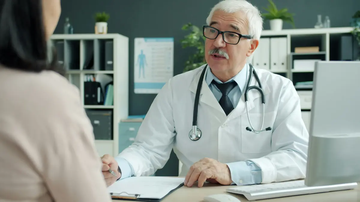 Doctor talking with a patient about treatment during a private practice appointment