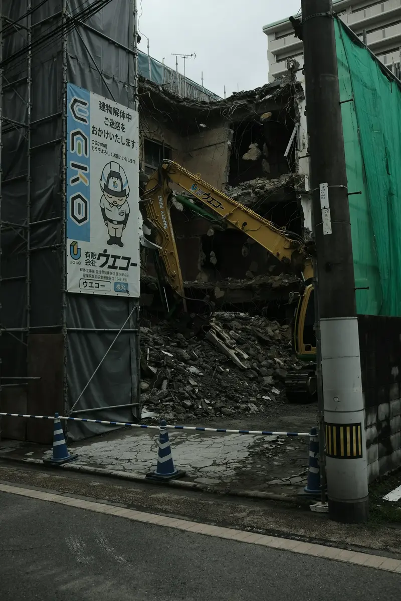 An excavator demolishing a building, the kind of active site work a demolition contractor uses to win the next job